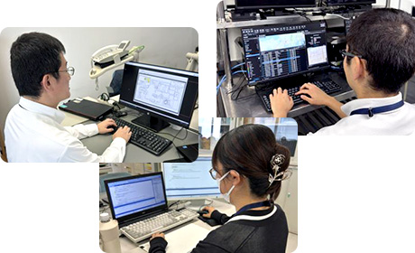 パソコンを使用して作業する3人の後ろ姿